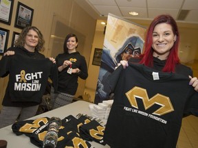 Chantelle Bacon, right, Mason's mother, is joined by volunteers Denise Sauve, left, and Kristen Movassut as they sell items from the Fight Like Mason Foundation at Windsor Regional Hospital's Met Campus on Dec. 21, 2016.