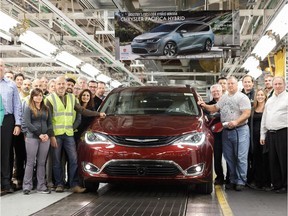 Workers from FCA's Windsor Assembly Plant gather around the first 2017 Pacifica Hybrid as it comes off the production line on Dec. 1, 2016.