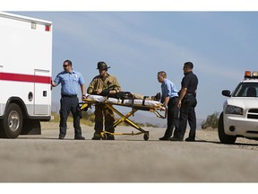 Paramedics transporting victim on stretcher. Photo by Getty Images.