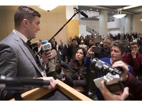 In this Nov. 18, 2016, photo, Richard Spencer, left, talks to the media at an Alt Right conference hosted by the National Policy Institute in Washington. CNN and host Jake Tapper have both apologized for an on-screen banner that Tapper said was "unacceptable" and "horrified" him when it appeared during his show on Monday, Nov. 21, 2016. The offending phrase appeared during a discussion among Jim Sciutto, subbing for Tapper on "The Lead," and two journalists about President-elect Donald Trump's support from the alt-right. The segment focused on white nationalist leader Spencer, whose anti-Semitic declarations Sciutto characterized as "hate-filled garbage." (Linda Davidson/The Washington Post via AP)