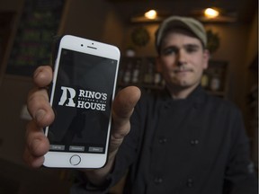 Joshua Fraser, owner of Rino's Kitchen and Ale House, displays a new smartphone application for the mid-town restaurant on Dec. 2, 2016.