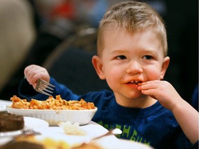 Mason Mazzali, 3, digs into his meal during the Windsor Salvation Army's annual Christmas dinner on Dec.14, 2016, at the St. Clair Centre for the Arts in downtown Windsor.