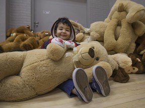 Emanual Habeel, 2, gets his hands on a new giant teddy bear at the Sparky Toy Drive distribution day event at Hotel Dieu Grace Healthcare, Saturday, Dec. 10, 2016.