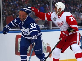 Tie Domi of the Toronto Maple Leafs gets his hat stolen by Chris Chelios of the Detroit Red Wings at Exhibition Stadium during the Centennial Classic Alumni Game in Toronto on Saturday December 31, 2016.