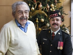 Second World War veteran Gordon Burnette, 94, is joined by Capt. Brad Krewench, right, at Huron Lodge retirement home on Dec. 9, 2016.