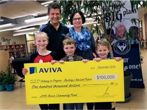 Tecumseh Vista Academy principal Paul Bisson and vice-principal Jen Lira and students Allisyn Shepherd, left, Connor Shepherd and Pierce Laflamme-Perrin pose with a cheque for $100,000 from the Aviva Community Fund on Dec. 6, 2016.