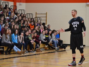 Windsor Express hopeful Nick Evans speaks to students at L'Essor secondary school during a break in the action on Dec. 19, 2016. The basketball practice was also a fundraiser for former student Ryan Toomer.