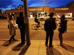 Holly Audet and Chenessa Solomon, right, speak with two men on Wyandotte Street during a survey to determine the number of homeless people living in Windsor on Tuesday, April 19, 2016.