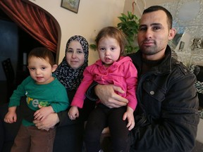 Ibrahim Tanbari and his wife Zeinab Mohammed Omar, left, are shown with their two children Hilal Tanbari and Hoda Ibrahim Tanbari, right, at their Windsor home on Dec. 21, 2016. The family moved to Windsor after fleeing Syria.