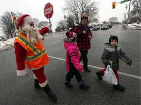 Crossing guard Ron Blais surprises students by dressing up as Santa on the last day of school for the holiday break on Dec. 23, 2016.