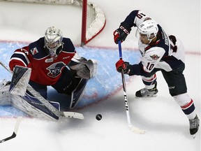 Jeremiah Addison of the Windsor Spitfires takes a shot on Kitchener Rangers goaltender Luke Opilka at the WFCU Centre Dec. 29, 2016.