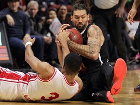 The Windsor Express' Brandan Kearney, bottom, fights for the ball with Jameson Tipping of the Orangeville A's during NBL of Canada action at the WFCU Centre on Friday, Dec. 30, 2016.