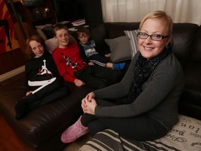 Sarah Johnson sits in her LaSalle home on Dec. 6, 2016 with her three boys — Miles, 9, left, Seth, 11, and Chance, 4. Johnson is one of the 1,202 cancer patients who was treated with diluted chemotherapy in 2012 and 2013.