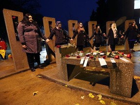 University of Windsor female engineering students, including Eleane Paguaga Amador, left, take part in the annual École Polytechnique massacre memorial on campus in Windsor on  Dec. 6, 2016.