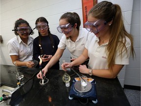 Holy Names students Daniela Espinosa, left, Gabriella Botica, Natalie May and Rachel Cote take part in a Grade 11 chemistry class at Holy Names Catholic High School in Windsor on Dec. 7, 2016.