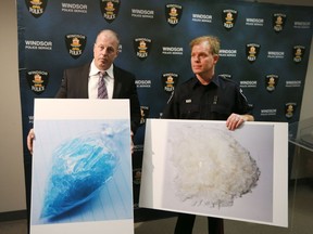 Windsor police Staff Sgt. Frank Providenti, left and Const. Andrew Drouillard display photos of seized crystal meth during a news conference announcing a major drug bust in Windsor.