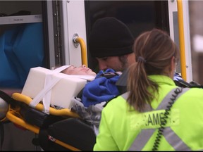 A child is transported into an ambulance by paramedics after he was struck by a vehicle on Sandwich Street on December 16, 2016.