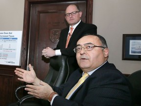 Mayor Drew Dilkens, back, and CAO Onorio Colucci discuss proposed City of Windsor 2017 budget during a news conference at City Hall, Friday, Dec. 16, 2016.