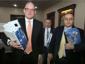 Mayor Drew Dilkens, treasurer Joe Mancina and CAO Onorio Colucci are shown with proposed City of Windsor 2017 budget at the end of a media conference at City Hall, Friday.