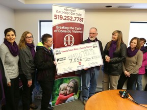 Members of Unifor Local 444 present a cheque for $7,556 to the Hiatus House on Dec. 16, 2016. Unifor members raised the money by selling purple scarfs for Hiatus House's Shine the Light on Woman Abuse campaign.