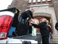Lakeside Plastics employees Brian Delcol and Heather Greer-Massey unload donated items at the Downtown Mission on Dec. 21, 2016. More than 400 employees from Lakeside Plastics in Oldcastle collected several truckloads of food items, clothing and toys and help those in need by donation to the Downtown Mission.
