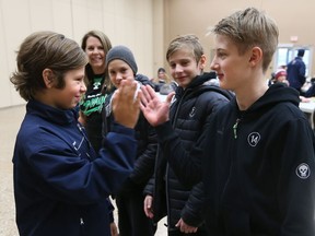 Riverside Rangers Chase Hull greets Czech Republic players Matj Skuhravy, Matj Kubat, and Jakub Svoboda during the 57th annual Riverside Rangers Minor Hockey Association International Bantam - Midget Hockey Tournament held at the WFCU Centre in Windsor. Hull's mom and billet Lana Vince looks on.