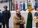 Local writer Grant Munroe of Biblioasis Press poses in front of mural created by Windsor-area artists on Pitt Street East on Dec. 28, 2016.
