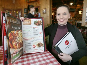 East Side Mario's manager Annie Lacroix is shown on Dec. 30, 2016 with a menu from the restaurant, which now lists calories for items.