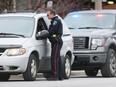 A Windsor police officer pulls over a driver on Ouellette Avenue Friday Dec. 30, 2016.