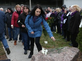 Unifor Local 444 members and the public participate in the National Day of Remembrance and Action on Violence Against Women, remembering the 14 women killed in Montreal's Ecole Polytechnique in 1989.  They also remember Mary Lou Hyjek, a Local 444 member who was killed at the hands of her husband in 1998. Here women place carnations on Hyiek's memorial stone outside the Windsor Assembly Plant.