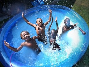 Chance Van Hoorn, 4, left, Julian Morgan, 4, Douth Jock, 6, and Lulu Jock, 6, splash and play while cooling off in Windsor on July 22, 2016.