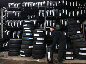 Heritage Tire Sales technician Brendon Moncrieff is shown at the Windsor, ON. business on Monday, December 12, 2016, where he was kept busy switching seasonal tires to winter tires.