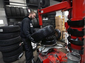 Heritage Tire Sales technician Brendon Moncrieff is shown at the Windsor business on Dec. 12, 2016, where he was kept busy switching seasonal tires to winter tires.