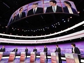 French politicians, from left to right, Arnaud Montebourg, Jean-Luc Bennahmias, Francois de Rugy, Benoit Hamon, Vincent Peillon, Manuel Valls and Sylvia Pinel, attend the first prime-time televised debate for the French left&#039;s presidential primaries in La Plaine Saint-Denis, near Paris, France, Thursday Jan.12, 2017. (Philippe Wojazer/Pool photo via AP)