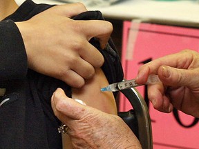 A student receives an immunization shot in this file photo.