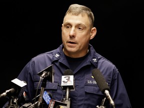 Capt. Michael Mullen of the U.S. Coast Guard answers questions during a news conference at Burke Lakefront Airport, Friday, Dec. 30, 2016, in Cleveland.