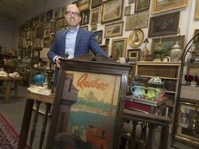Maurice Ruelland, owner of Ruelland's Antiques, is pictured next to a poster booth that was once in the interior of the old Walkerville Train Station, Saturday, January 7, 2017.