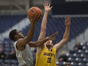 Windsor's Micqueel Martin, left, is defended by Queen's Tanner Graham during OUA men's basketball between the Windsor Lancers and the Queens Gaels at the St. Denis Centre on Jan. 8, 2017.