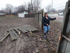 Shirley Watson is shown next to her damaged fence on Jan. 3, 2017, at her home at Karen Street and Cabana Road in Windsor. A car smashed through the fence Monday evening and Watson is concerned about safety in the area, specifically with the widening of Cabana set to get underway. Roseland Public School can be seen in the background on the right.
