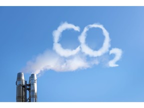 Smoke of chimney writing CO2 in the sky. Image by Getty Images.