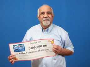 Alibhai Fidahossen of Windsor holds his $100,000 prize cheque from adding Encore to his Lottario ticket. Photo taken on Jan. 4, 2017.