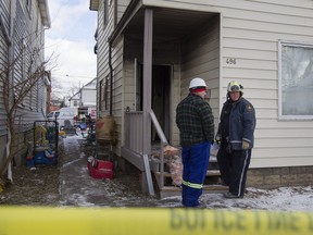 Fire investigators work at the scene of a house fire at 496 Caron Ave, Sunday, Jan. 8, 2017.
