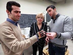 Mechanical engineering students at the University of Windsor have been recognized on an international stage for their research in designing a 3D printable hand brace that can assist people with connective tissue disorders. Students Hamed Kalami, left, and Andre Khayat are shown with the device and Dr. Jill Urbanic, associate professor, mechanical, automotive and materials engineering department on Wednesday, Jan. 18, 2017.