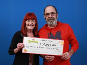Windsor residents Frank Gratton and his wife Heather hold the $50,000 prize cheque they received thanks to Frank's Instant Crossword win.