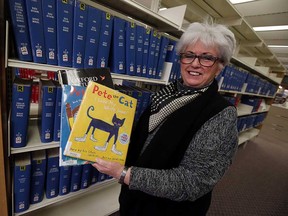 Windsor Public Library CEO Kitty Pope holds Pete the Cat children's picture books and the Oxford English-Arabic picture dictionary at the central branch on Jan. 19, 2017.