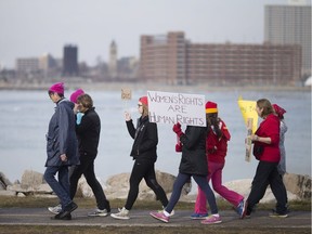 Locals march along Windsor's riverfront in solidarity with the Women's March protesting the presidency of Donald Trump Saturday, Jan. 21, 2017.