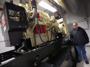 Managed Network Systems, Inc. president and owner Clayton Zekelman is shown near a heavy duty diesel generator at the company's networking systems facility in Windsor on Monday, Dec. 19, 2016.