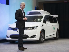 CEO of Waymo, Google's self-driving car division, John Krafcik, unveils the autonomous Chrysler Pacifica Hyrbid minivan at the North American International Auto Show at Coba Hall on Jan. 8, 2017.