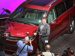 Fiat Chrysler brand chief Tim Kuniskis poses next to a Windsor-built Pacifica after it was awarded the utility vehicle of the year at the North American International Auto Show on Jan. 9, 2017, in Detroit.