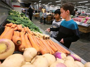 Darren Han, left, and Nathan Wills from D.M. Eagle School check out vegetables during a Nutrition in the Aisles tour at the Zhers store at Tecumseh and Lauzon roads in Windsor on Tuesday, Jan. 17, 2017.